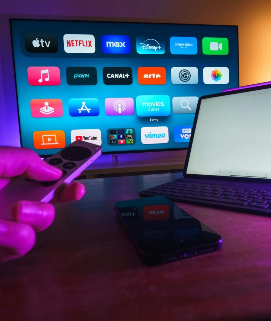 pexels-photo-30366457-30366457 A cozy home setup featuring streaming services on smart TV, tablet, and smartphone.